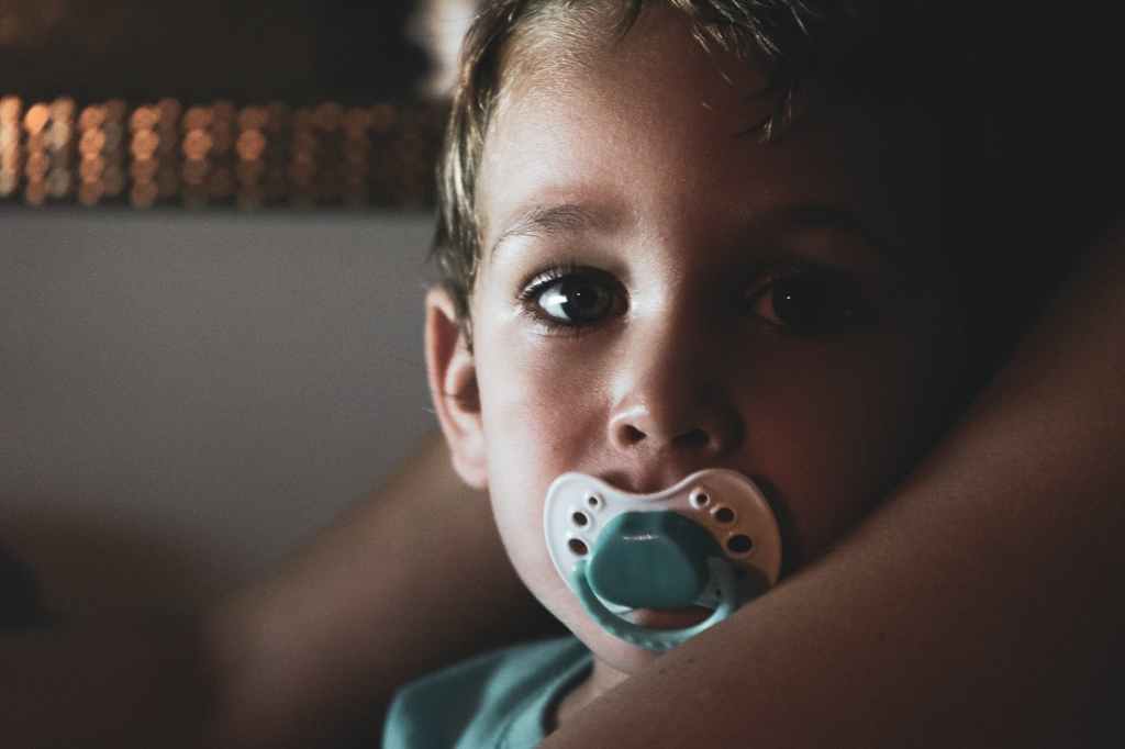 young boy with pacifier