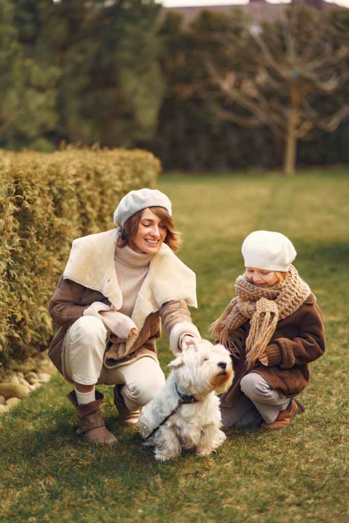 child and mother caring for dog