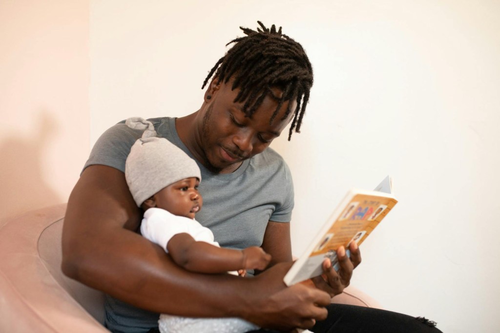 Dad reading with young child. Helping kids learn time through real-life conversations.